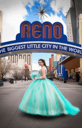 Quinceañera in a teal ball gown posing beneath the Reno arch